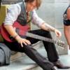 Keith Urban sitting on the steps of a tattoo parlor in downtown Nashville for a photo shoot with Vogue.  Photo by Kelly Jean